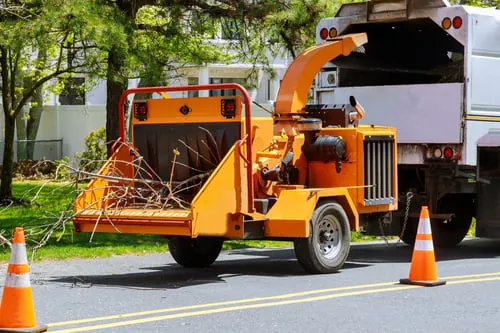 Tree service chipper truck set up on a residential street